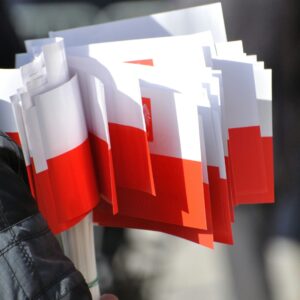 a person holding a bunch of red and white papers